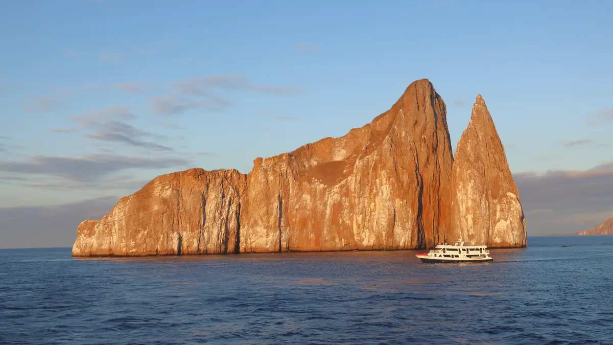 hub hero 1200 - Dana Tours Kicker Rock (León Dormido) glowing at sunset with a yacht, San Cristóbal, Galápagos
