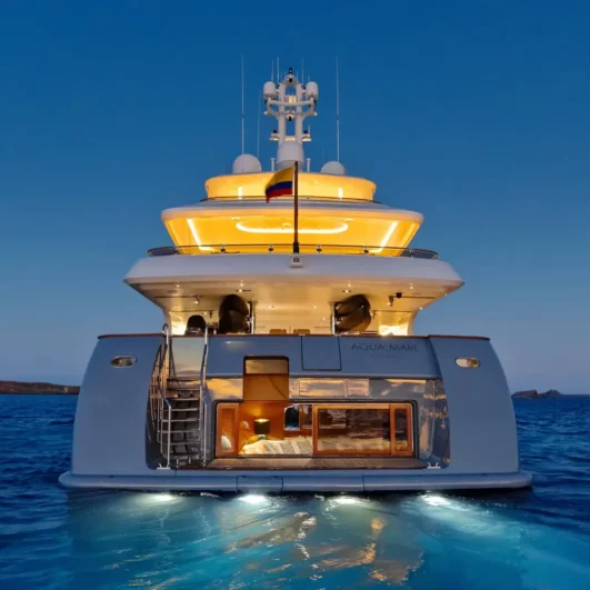 The Aqua Mare superyacht lit up at dusk in the Galápagos