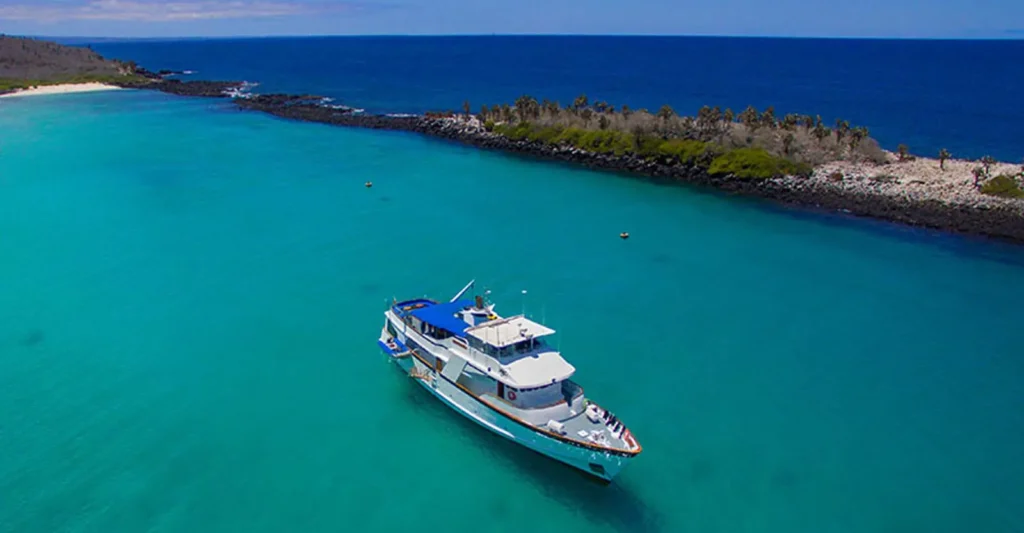 The Beluga yacht anchored in a turquoise Galápagos bay