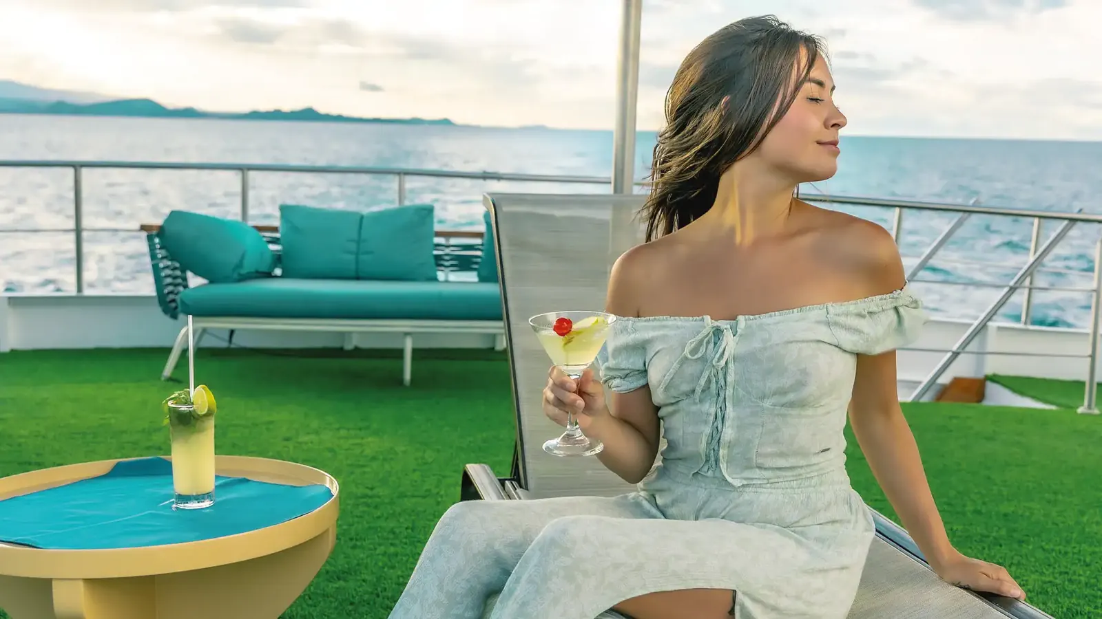 Guest with a drink on the Bonita sundeck
