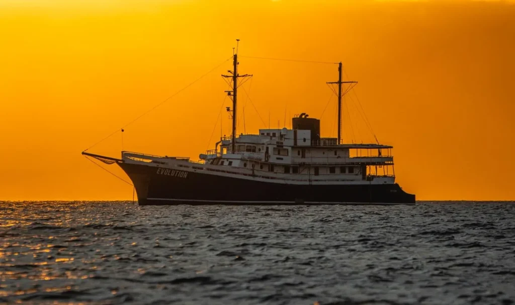 Evolution yacht at sunset in the Galápagos Islands