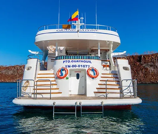 The Grand Daphne motor yacht anchored off a Galápagos cliff