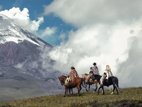 home andes riders 480 - Dana Tours Riders on horseback below a snow-capped volcano in the Ecuadorian Andes
