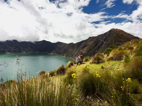 Hikers above the Quilotoa crater lake