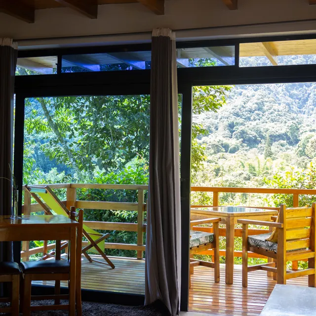 A luxury bungalow at Las Terrazas de Dana opening onto its balcony and the forest