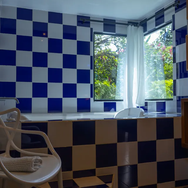 A hot tub by a window onto the cloud forest in a luxury bungalow