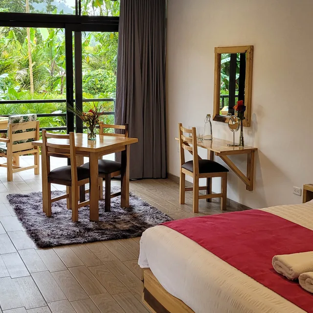 A master suite at Las Terrazas de Dana: king bed, sitting area and a terrace onto the cloud forest