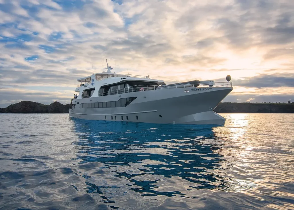 Tribute luxury yacht at sunset in the Galápagos Islands